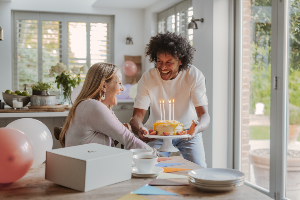 This image shows two people celebrating a milestone - bringing joy to the day with a birthday gift hamper 