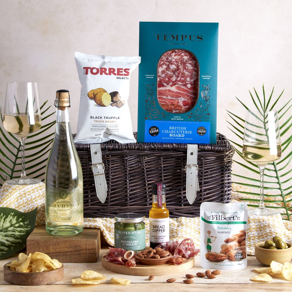 This image shows a corporate thank you gift for clients - a gift hamper filled with artisanal food and drinks.