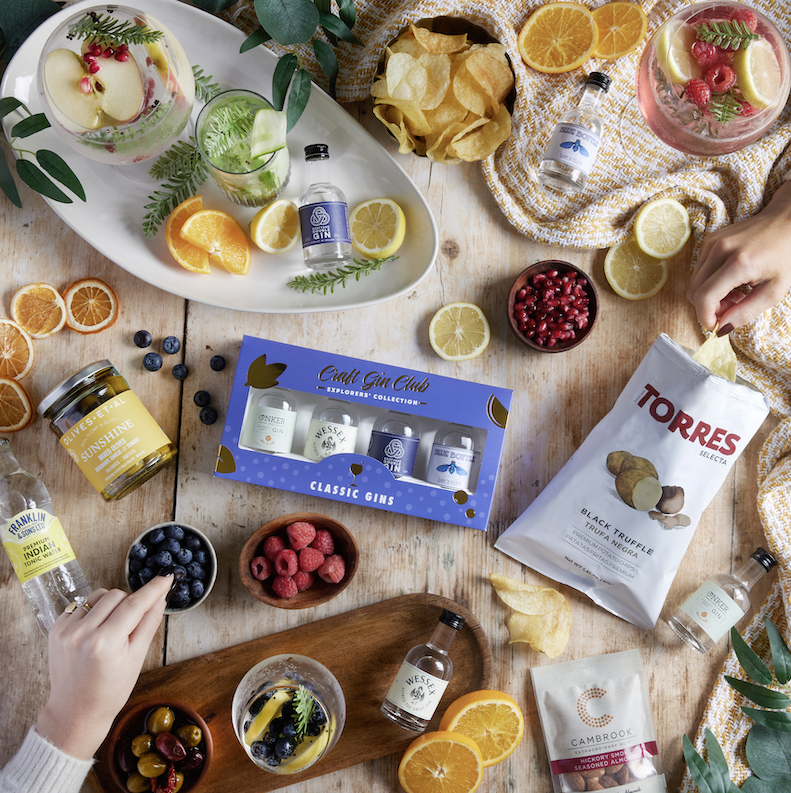 This image shows a carefully curated  gift hamper featuring artisanal foods and drinks  